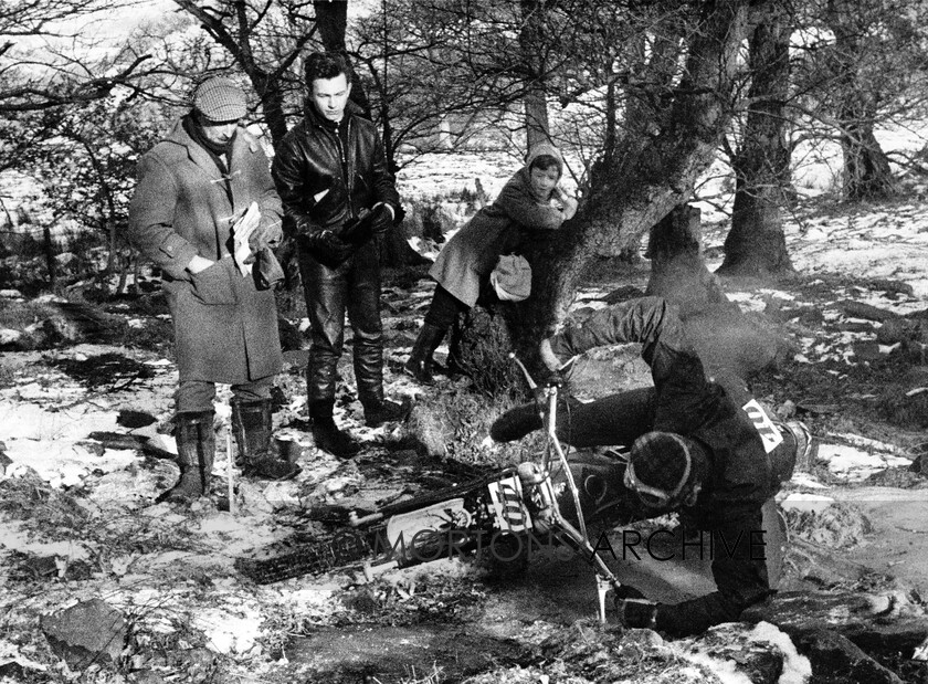 NNC-T-A-38 
 NNC T A 038 - Ralph Venables (ina a cap and duffle coat) watches while Peter Atkinson crashes in a icy stream during the 1963 St. David's Trial at Neath. He was riding a 246cc Cotton 
 Keywords: Mortons Archive, Mortons Media Group Ltd, Nick Nicholls, Trials