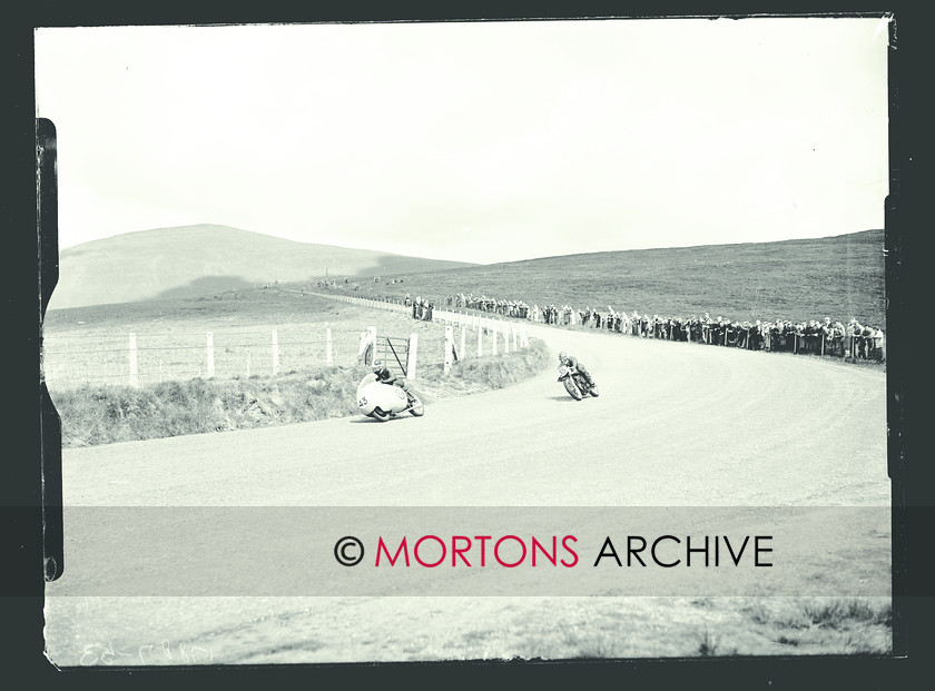 053 SFTP SENIOR TT 1957 05 
 A golden day at the Senior TT, 1957 - Guzzi-mounted John Clark streaks ahead of K Willis (Norton) 
 Keywords: 1957, Glass plate, Isle of Man, Mortons Archive, Mortons Media Group Ltd, Straight from the plate, The Classic MotorCycle, TT