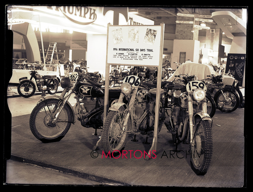 062 GLASS PLATES EARLS CT-6 
 The Earl's Court Show, November 1956 - Resplendent in German mud, the ISDT winning Matchless singles. 
 Keywords: 2013, Earls Court, Glass plate, May, Mortons Archive, Mortons Media Group, Show, Straight from the plate