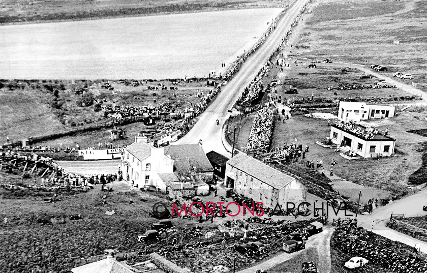 Manx 22D 
 22D – A great crowd have turned out at the Creg to watch the 1951 Junior TT. 
 Keywords: 2012, Exhibition of historic images, Manx Grand Prix, Mortons Archive, Mortons Media Group, Mountain Milestones - Memories from Mona's Isle