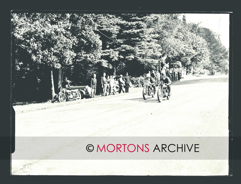 SFTP April 2012 - 2 
 Digby Larque (84, EMC-Puch) is passed by Brian Pulslow (91, Triumph) in the 125cc race. 
 Keywords: 2010, Aberdare road races 1954, April, Mortons Archive, Mortons Media Group, Straight from the plate, The Classic MotorCycle