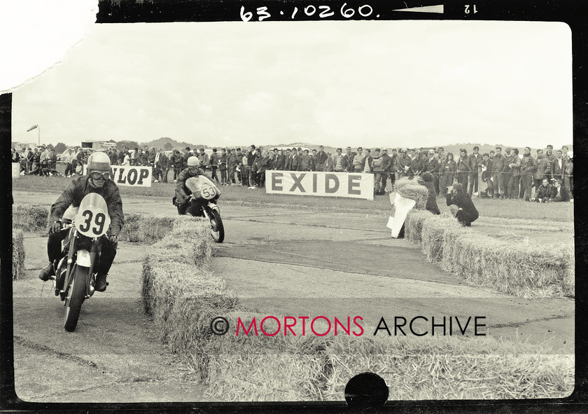 062 glass plate 09 
 The number 39 BSA 650cc ridden by Donald Face and Eric Denyer coasts into the pits, as the streamlined number 53 Arter Bros AJS 650cc 31 CSR (Peter Evans and John Jacques) storms through the narrow right hander. 
 Keywords: 1963, 2013, Glass plate, June, Mortons Archive, Mortons Media Group, Straight from the plate, The Classic MotorCycle, Thruxton 500 mile race