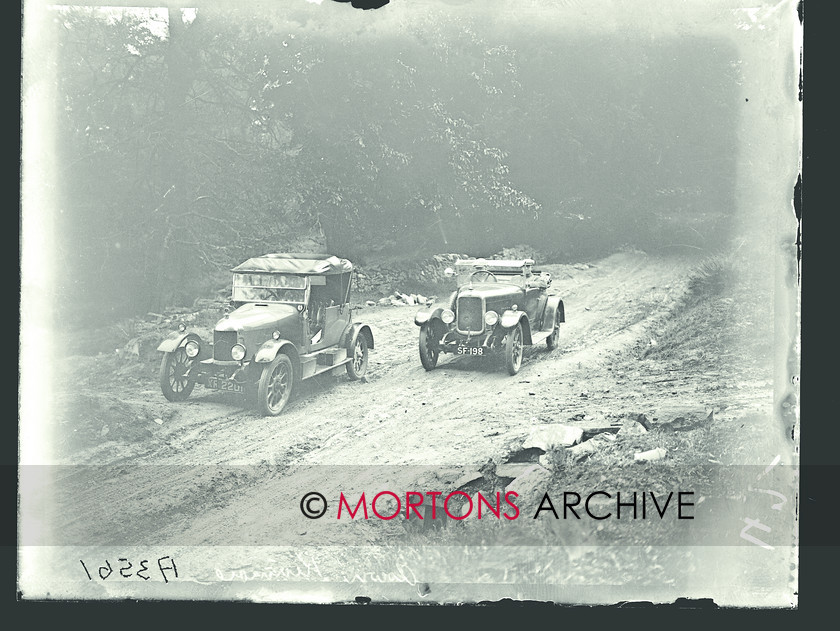 053 SFTP 08 
 The Scottish Six Days Trial, 1924 - two cars jostle for position on some bumpy ground. 
 Keywords: 1924, Glass plate, Mortons Archive, Mortons Media Group Ltd, Off road, Scottish Six Day Trial, Straight from the plate, The Classic MotorCycle