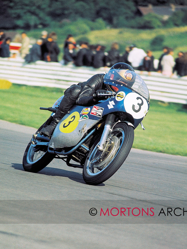 Sheenebookazine21 
 Sheene tucks behind the screen of his Seeley-framed TR500 Suzuki and pushes the twin-cylinder engine up to its 8000rpm red line. This shot was taken at the Hutchinson 100 on 8 August 1971. The previous weekend he had won his third 125 GP of the season at Imatra. A few weeks later he broke a wrist in a crash at Hengelo in Holland - the first of many bones he was to break during his 14 years as a GP racer. If the World Championships had been scored the way they are now he would have taken the 125 title that year, his first as a professional racer. 
 Keywords: Barry Sheene, Mortons Archive, Mortons Media, Mortons Media Group Ltd, motor cycle, motorcycle, Sheene