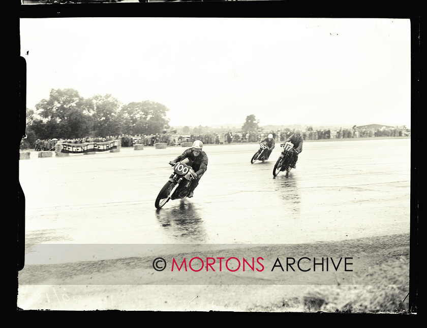 053 SFTP 1951 Thruxton A04 
 Wet day at Thruxton, August 1951 - Geoff Duke (100, Manx Norton) and Bill Doran (90, AJS 7R) lap Johnny Hodgkin on his Mk. VIII KTT Velocette. 
 Keywords: 2014, April, Glass Plates, Mortons Archive, Mortons Media Group Ltd, Straight from the plate, The Classic MotorCycle, Thruxton