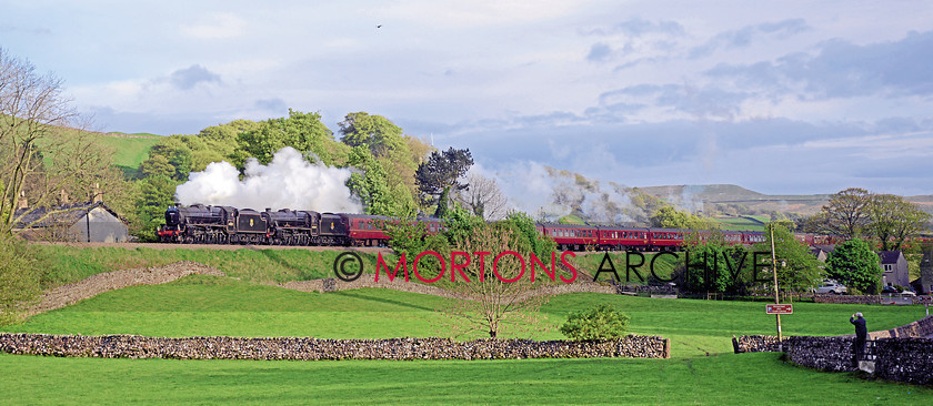 048 44871 Settle 
 Ian Riley's 'Black Fives' nos 44871 and 45407 head north away from Settle on May 9. 
 Keywords: 2014, Heritage Railway, Issue 190, Mortons Archive, Mortons Media Group Ltd